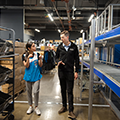 Bastian Solutions engineer showing Decathlon retail worker the new microfulfillment system