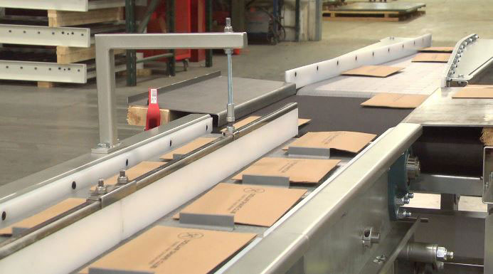 Product merges on conveyor